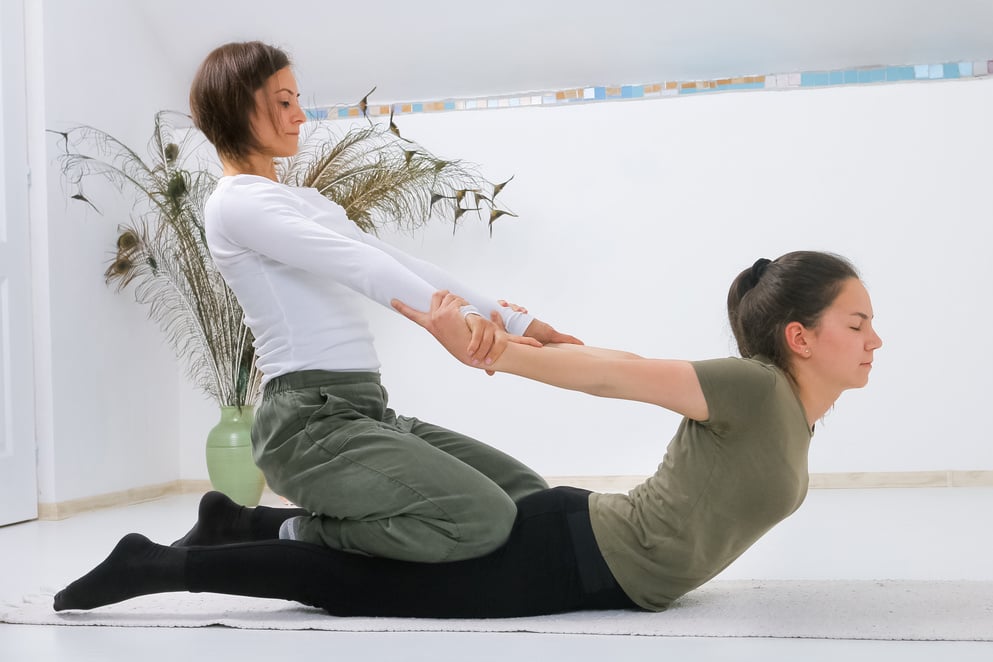 Teenager getting Shiatsu massage from Shiatsu masseuse